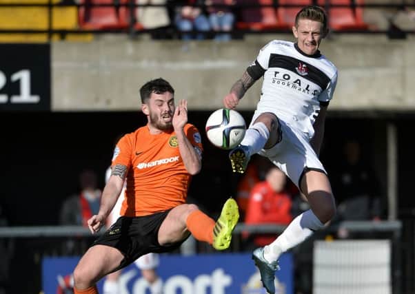 Carrick's Brian McCaul  in action with Crusaders' Mathew Snoddy