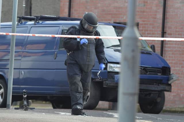 A member of the bomb squad looks for evidence at the scene of last Friday's attack in east Belfast