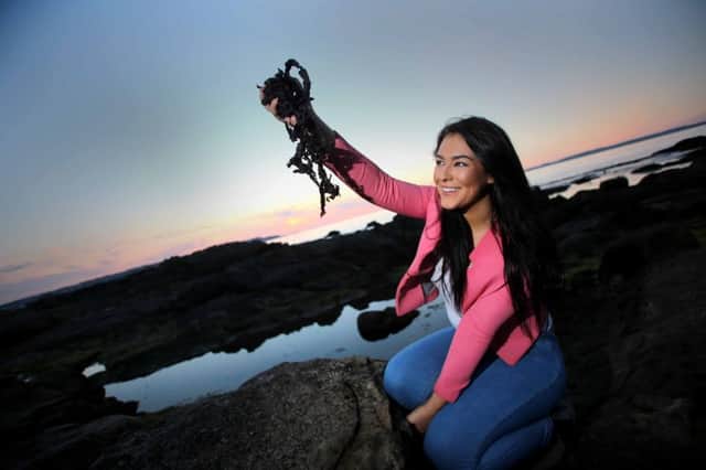 McAuley Multimedia 21August 2015 Laura McCaughan from Ballycastle a tourism undergraduate at the John Hope University Liverpool samples some dulse and yellowman in her home town as she gets ready for the Oul Lammas Fair.Ould Lammas Fair, Co. Antrim 'The Oul Lammas Fair' has taken place annually in Ballycastle, Co Antrim, since the seventeenth century. Celebrated on the last Monday and Tuesday in August, the fair marks the end of summer and beginning of harvest. The origins of the fair are embroiled in the myths and legends of Ireland, although the tradition such festivals can be found in many cultures throughout the world. The Lammas Fair traditionally attracts thousands of people from around the world, and features more than 400 stalls of craft, bric-a-brac and farm produce. Local specialities include 'Yellow Man', a sweet honeycomb candy, and a red seaweed known as 'dulse'. Street entertainment, including face-painting and pony rides, lends a carnival atmosphere, while traditional music sessions in the pubs
