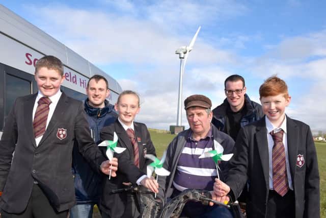 The Year 11 Saintfield High School agriculture class were recently given an education tour of the wind turbine on Henry Dormans farm by Stuart Clarke and Colin Power from Northern Ireland wind energy company, Simple Power, to learn first-hand about the power of wind turbines and wind energy in action in their local area. Pictured from the Year 11 agriculture class is, Andrew Fox, Danielle Connolly and Stephen Rooney.
