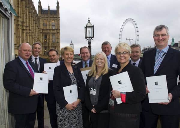 MPs in Westminster holding the recently launched Diary APPG report on dairy and public health.