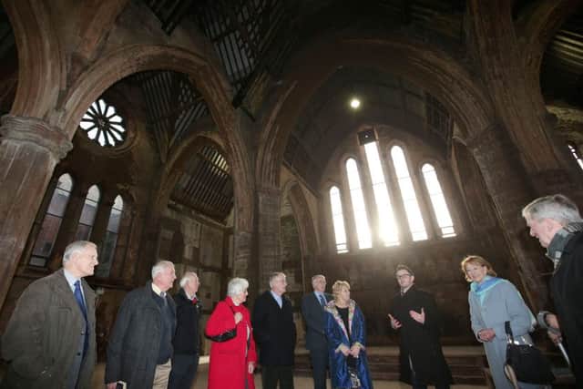 Shane Ritchie of the Belfast Buildings Trust explains to former ministers and parishioners the emergency work that saved Carlisle Memorial. Picture by Jonathan Porter/PressEye