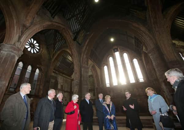 Shane Ritchie of the Belfast Buildings Trust explains to former ministers and parishioners the emergency work that saved Carlisle Memorial. Picture by Jonathan Porter/PressEye