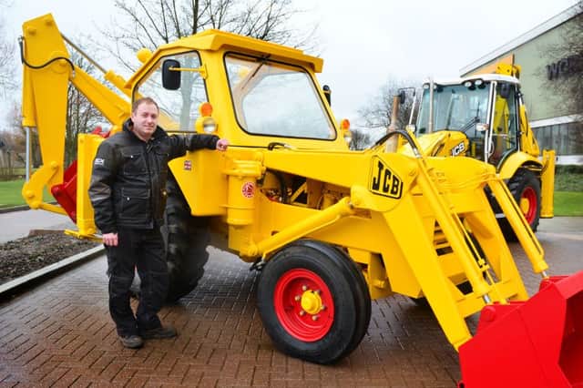 Julian Carder pictured with the JCB 3 he has lovingly restored