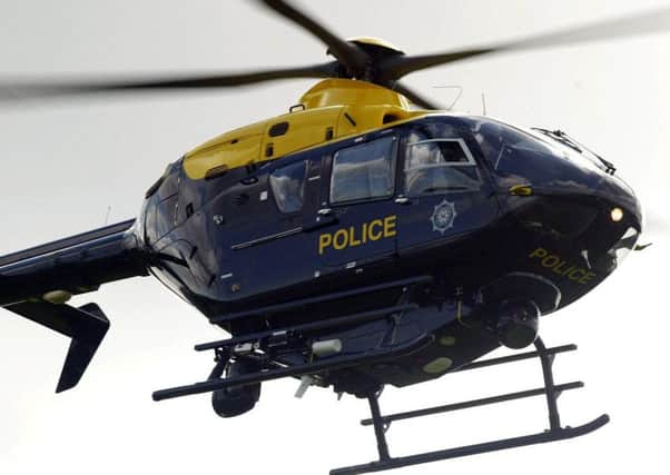Police arrested a 23-year-old man after a laser was shone at a PSNI helicopter