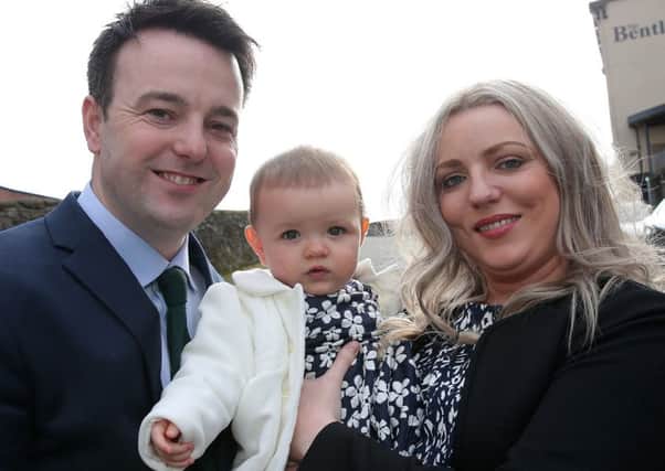 SDLP leader Colum Eastwood outside St Columb's hall with wife Rachael and daughter Rosa