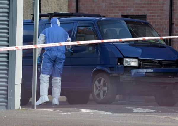 Forensics at the scene on March 4 after Adrian Ismay's van was targeted by a booby trap bomb. Photo Colm Lenaghan/Pacemaker Press