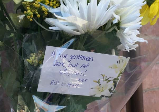 Flowers left at the scene in Hillsborough Drive in east Belfast this afternoon as news broke that prison officer Adrian Ismay had died