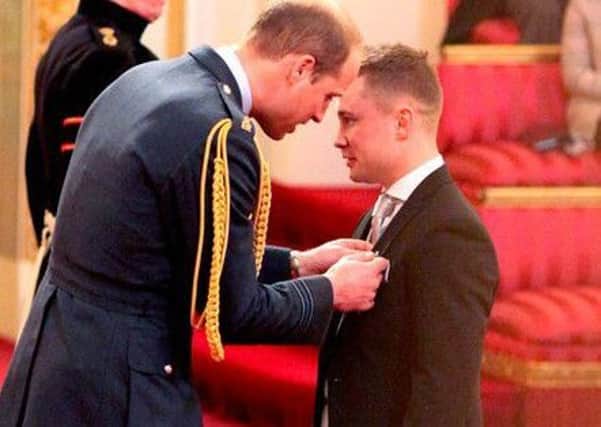 Carl Frampton receiving his MBE from the Duke of Cambridge.