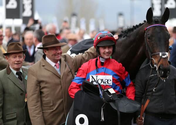 Nico de Boinville (centre) celebrates with Trainer Nicky Henderson (second from left) after winning the Betway Queen Mother Champion Chase with Sprinter Sacre