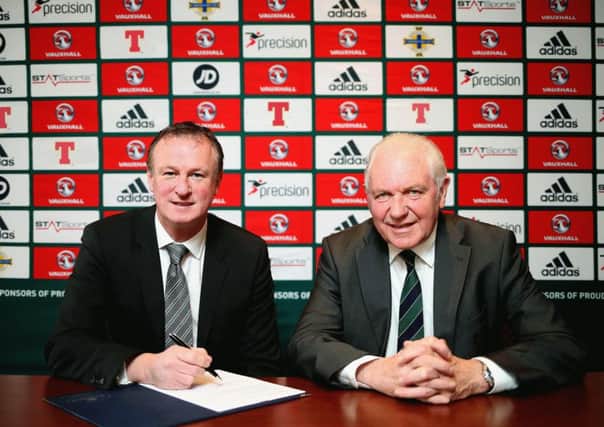 Northern Ireland manager Michael O'Neill signs his new four year contract alongside IFA president Jim Shaw