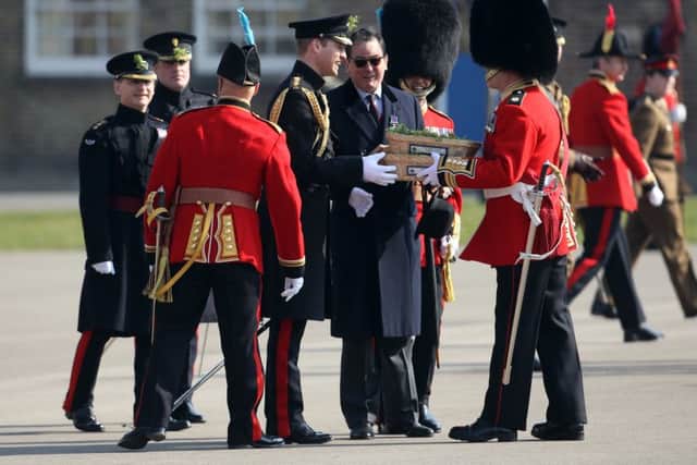 The Duke of Cambridge (centre) prepares to present sprigs of shamrock to the Irish Guards as he visits Cavalry Barracks in Hounslow, west London,