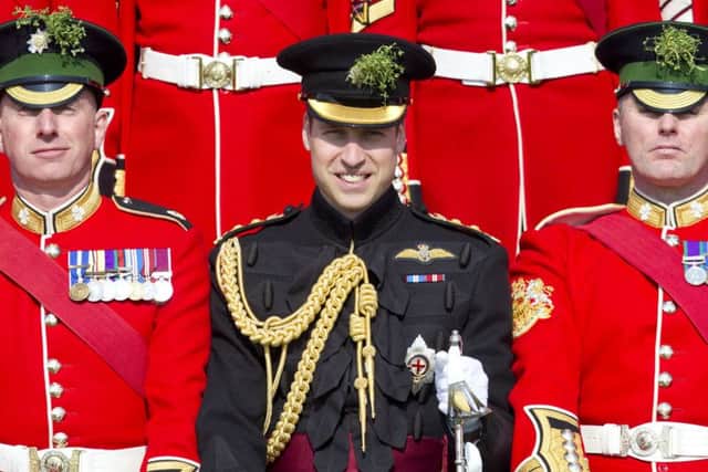 The Duke of Cambridge poses for the Warrant Officer and Sergeant's Mess group photo with the Irish Guards