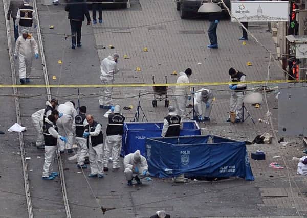 A forensic team works at the scene of the explosion in the heart of Istanbul