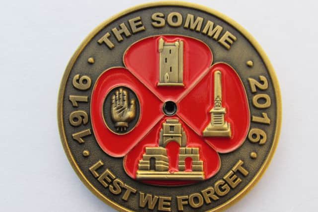 The coin contains images of Somme tributes including the Ulster Tower and the Orange Order memorial