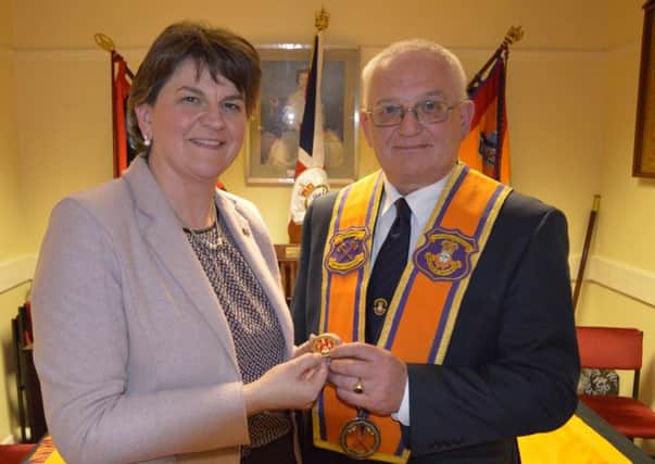 Portadown District Master Darryl Hewitt presents First Minister Arlene Foster MLA with the commemorative coin marking the anniversary of the Battle of the Somme