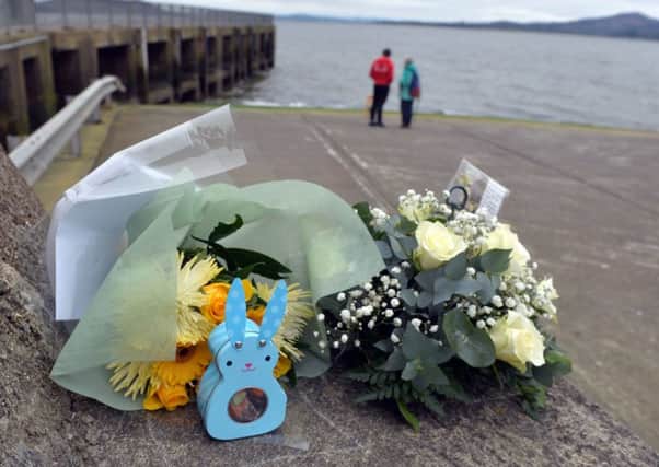 PACEMAKER BELFAST 21/03/2016  
Flowers left  at the Scene at the Pier in Buncrana Co Donegal, after Five people, including children, have died after a car went off a pier.Police said a man, a woman, two boys and another female, whose age is not yet known, died after the car entered the water at Buncrana on Sunday.
A passer-by helped rescue a baby girl from the car. She is described as being in a stable condition in hospital.
 Picture Colm Lenaghan/  Pacemaker