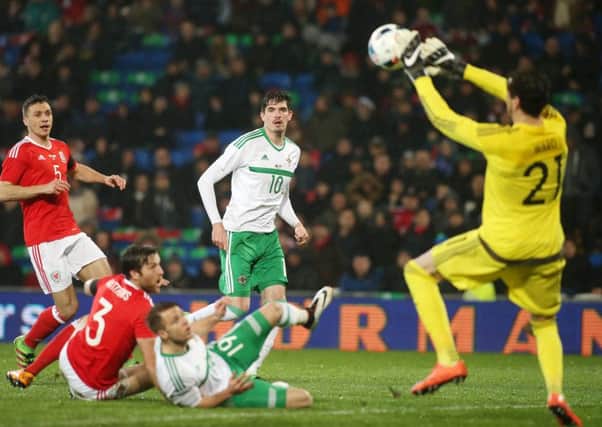 Northern Ireland's Kyle Lafferty has a shot on goal saved by Wales' goalkeeper Wayne Hennessey.
