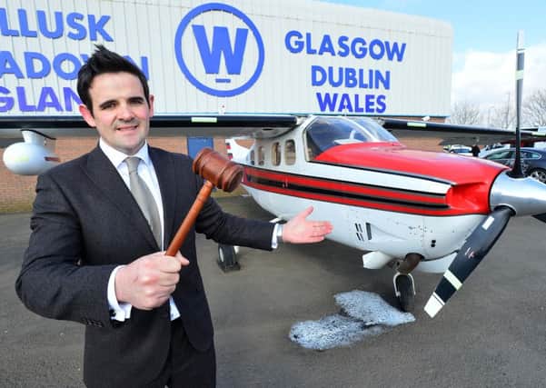 Aidan Larkin of Wilsons Auctions with the Cessna airplane which is going under the hammer on March 31