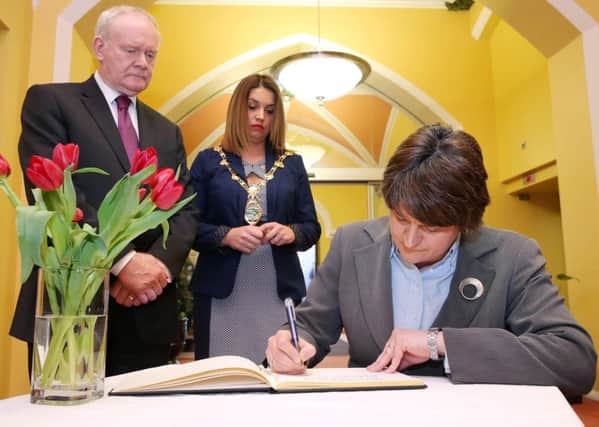 First Minister, Arlene Foster, deputy First Minister, Martin McGuinness and Mayor of Derry City and Strabane, Elisha McCallion pictured signing the book of condolence for Sean McGrotty, Mark McGrotty, Evan McGrotty, Ruth Daniels and Jodie Lee Daniels