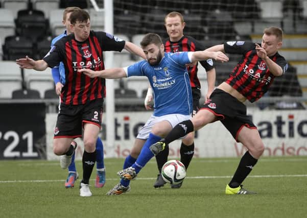Crusaders Andy Mitchell and Billy joe Burns  in action with Dungannon's Cormac Burke