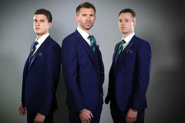 Paddy McNair, Gareth McAuiley and Jonny Evans model the new suits that  Northern Ireland players and  officials will wear in France this summer