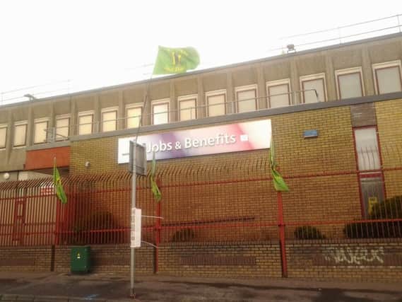 IRA flags flying from the benefits office on the Falls Road