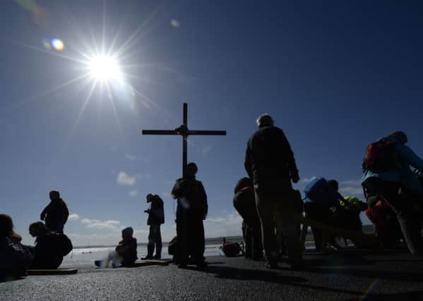 The history of Ireland is full of Easter events, but there is an older Easter story that could bring people together. Above pilgrims cross to the Holy Island of Lindisfarne in Northumberland during the Christian Easter pilgrimage on Good Friday. Photo: Owen Humphreys/PA Wire