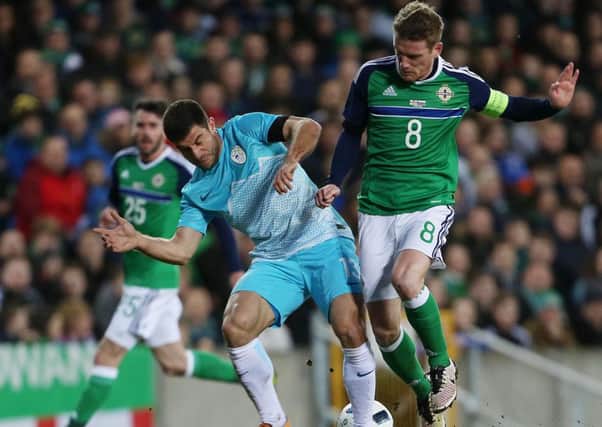 Northern Ireland captain Steven Davis and Slovenia's Bojan Jokic