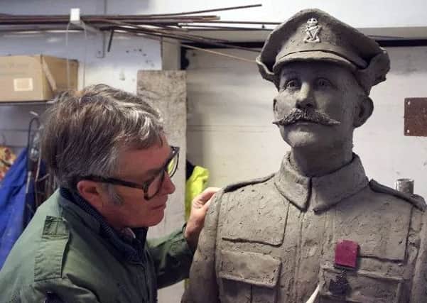 Sculptor David Annand putting the finishing touches to his model of Robert Quigg VC before it is cast in bronze