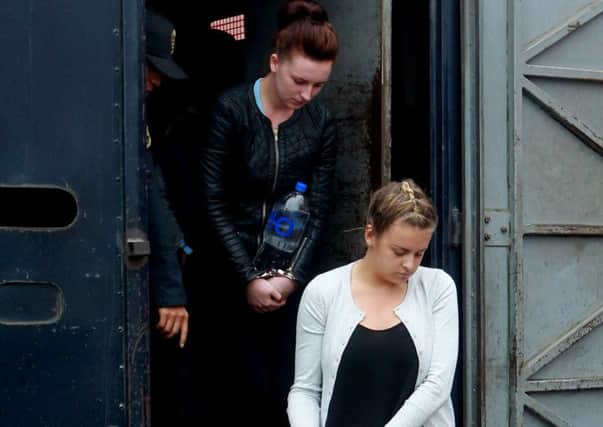 Police escort Melissa Reid, of Britain, front, and Michaella McCollum Connolly, of Northern Ireland, formally charged for drug trafficking, to a hearing, in Lima, Peru, Tuesday, September 24, 2013