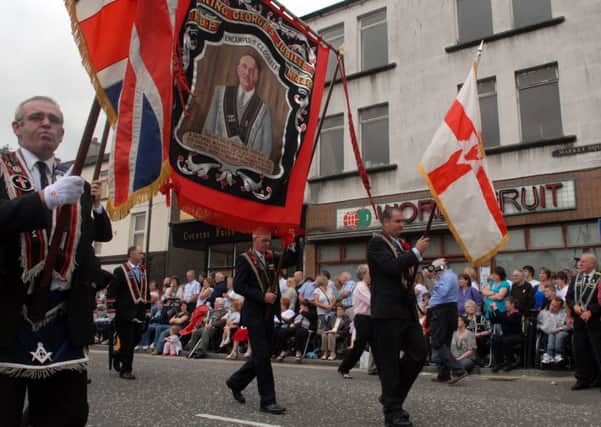 Members of Closkelt RBP 449 pass close to the spot where the late Sir Knight William Herron was murdered  in Dromore. Mr Herron is commemorated on their banner.