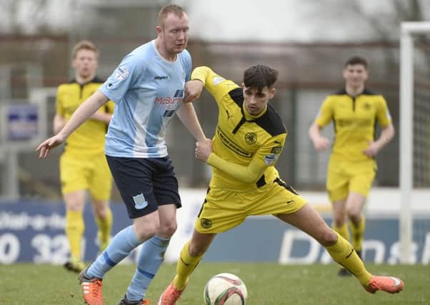 Kyle McVey, who scored Ballymena United's first goal in today's game at the Showgrounds, tussles with Cliftonville's Jay Donnelly. Picture: Press Eye.