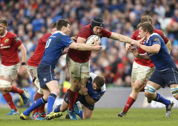 r
Munster's Tommy O'Donnell is closed down by Leinster