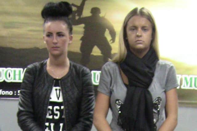 Michaella McCollum, left, and Melissa Reid, stand behind their luggage after being detained at the airport in Lima, Peru, in August 2013