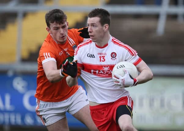 Derry's Niall O'Loughlin in action against Armagh's Ethan Rafferty