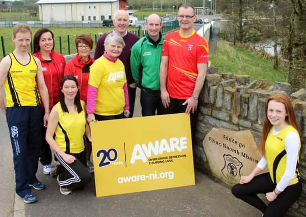 Looking ahead to the Beragh 5 on April 9 are (L-R): Niall Heaney, Dervla Devlin, Kate Corrigan, Margaret McCrossan (Aware), Hugh McNamee (club chairman), Darryl Meenagh and Adrian Donnelly (race co-ordinator). Front: Aileen McCann and Niamh Heaney.