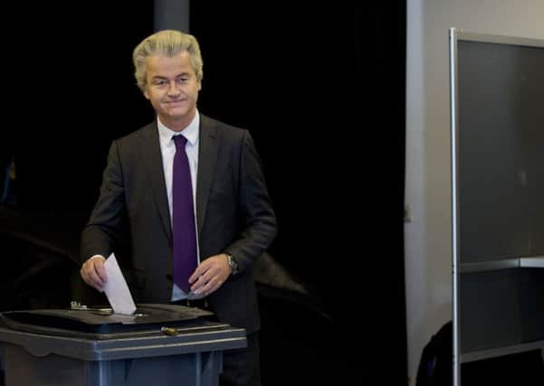Firebrand Dutch lawmaker Geert Wilders casts his vote in a non-binding referendum on the EU-Ukraine association agreement in The Hague, Netherlands, on Wednesday. The vote was seen by opponents of the 28-nation EU bloc as an opportunity to express their anger at alleged lack of democratic rights for EU citizens.(AP Photo/Peter Dejong)