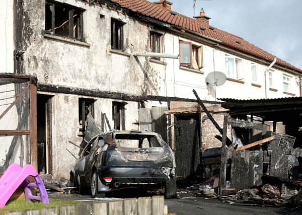 Three people have escaped injury after a car was set on fire and pushed up against their home in Richhill, Co Armagh