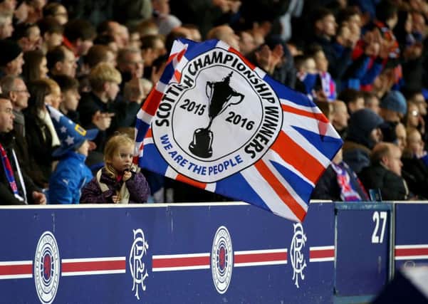 Rangers fans celebrate after the beating Dumbarton on Tuesday night to win the Ladbrokes Scottish Championship