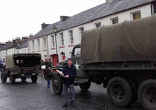 Glenarm resident Alan Nesbitt poses in front of World War 2 army vehicles used during filming of TV drama 'My Mother and Other Strangers." INLT-15-700-con