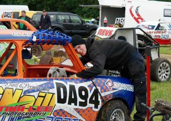 Tragic motorsports fan Scott McNeill, pictured with a car which he and his father had worked on together