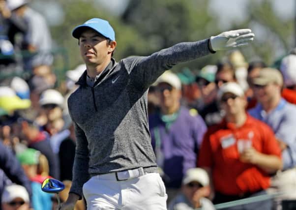 Rory McIlroy indicates the direction of his tee shot on the eighth hole