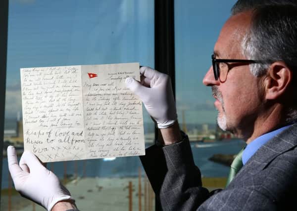 Tim Husbands, chief executive of the Titanic Belfast museum, holds a letter from a passenger, Esther Hart and her seven-year-old daughter Eva, penned just hours before the ship sank in April 1912