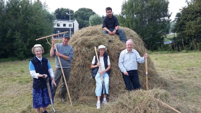 The Sisters of Mercy pitch in alongside volunteers to help make a traditional hay ruck at Monastery Meadows in Enniskillen