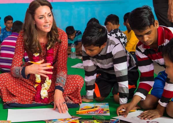 The Duchess of Cambridge draws with children during a visit to a children's centre run by the charity Salaam Baalak, which provides emergency help and long term support to homeless children at New Delhi railway station, on day three of the Royal visit to India and Bhutan