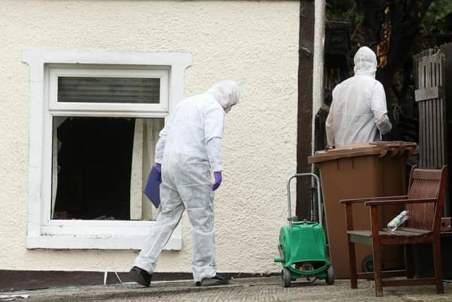 Forensic officers at the scene of the fatal fire at Thorndale Park, off the Hillsborough Road, in Carryduff, in September 2014.
Picture: Pacemaker