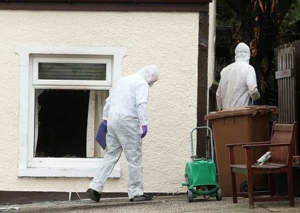 Forensic officers at the scene of the fatal fire at Thorndale Park, off the Hillsborough Road, in Carryduff, in September 2014. 
Picture: Pacemaker
