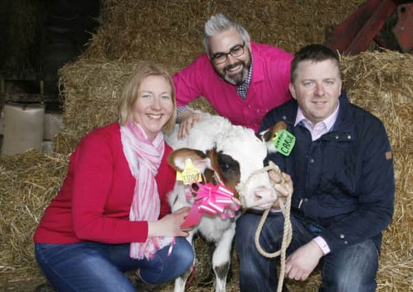 Dairy farmers Ivor and Cecilia Broomfield, Armagh, and Dr Kienan Savage, Centre for Cancer Research and Cell Biology at Queen's University, are pictured with Moneyquin Aikman Carol Red, which will be auctioned for the CCRCB charity at Holstein NI's Open Day.