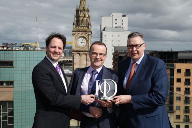 Richard Ennis, left, of First Trust and IoD chair Paul Terrington, right, with Brian Murray of The Workspace Group named Third Sector Director of the Year